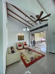 Kampong Bukit KatilTraditional Melaka Homestay with Private Pool的带沙发和吊扇的客厅