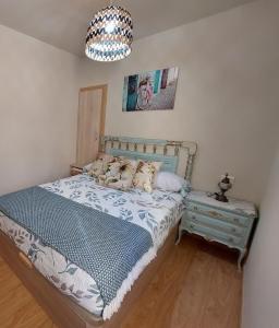 FOGAR CAÑÓN DO SIL - Ribeira Sacra的一间卧室配有一张床和一个吊灯
