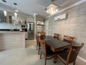 邦巴斯Apartamento a 60m da praia de Bombas的厨房以及带桌椅的用餐室。