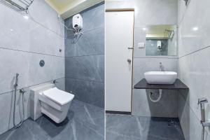 艾哈迈达巴德FabHotel Bliss的一间带卫生间、水槽和镜子的浴室