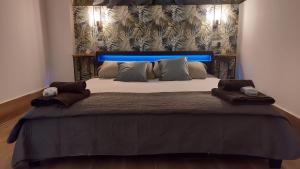 马德里Aparthotelmadridea, renovated quiet apartments, Madrid的一间卧室配有一张大床和蓝色床头板