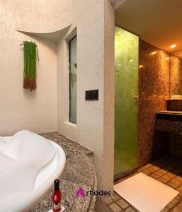 累西腓Rhodes Hotel Recife的设有带浴缸和淋浴的浴室。