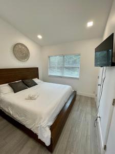劳德代尔堡Modern Riverview Apartments的一间卧室配有一张床和一台平面电视