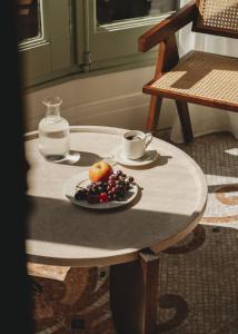 巴塞罗那Casa Llimona Hotel Boutique的一张桌子,上面放着一盘水果和一杯咖啡