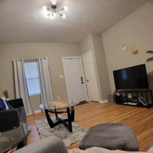 印第安纳波利斯2 bd 2 bath in Fountain Square- 5 Min to Downtown的客厅配有桌子和平面电视。