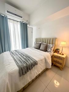 马尼拉City Nest Makati with Rooftop pool and Free Netflix的一间卧室设有一张大床和一个窗户。