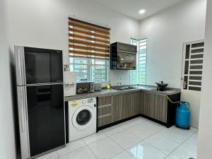 加央Aisy Guest House - MUSLlM Only的厨房配有洗衣机和烘干机