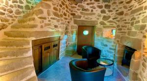 Cléden-Cap-SizunMOULIN DE KERNOT的一间设有壁炉和石墙的客房