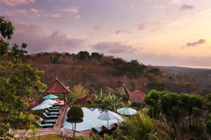 蓝梦岛Poh Manis Lembongan的享有带游泳池和遮阳伞的度假村景色