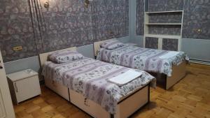 埃里温Royal Boutique Hotel on Kievyan的紫色床单的客房内的两张床