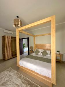 达哈布Babushka Boutique Hotel-Dahab的一间卧室配有一张木天蓬床。