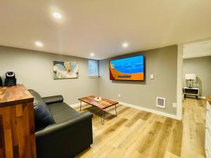 西雅图Green Lake 1st Line Home C Full Modern Remodeled的客厅配有沙发和墙上的电视
