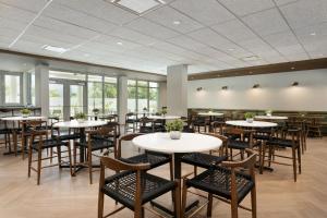 卢基约Fairfield by Marriott Luquillo Beach的用餐室设有桌椅和窗户。