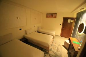 As SuwaysGreen House Hotel的酒店客房,设有两张床和镜子
