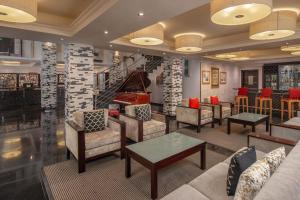 拉各斯拉各斯库拉莫水万豪Protea酒店的大堂配有沙发、桌子和钢琴