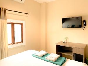 Hotel Syariah Larismanis客房内的一张或多张床位