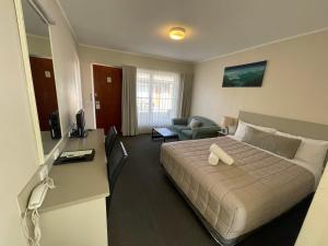 诺拉乔治巴斯汽车旅馆的酒店客房设有一张大床和一张书桌。
