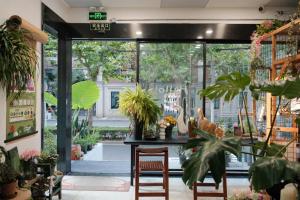 上海上海城市公园酒店(静安MOHO店)的一间设有桌子和一些植物的房间