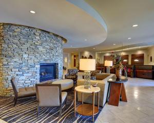 兰开斯特伊甸园度假村及套房BW精选酒店的客厅设有石墙和壁炉。