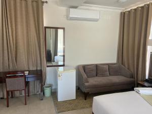 哈博罗内Cycad Palm Guest House Gaborone的客厅配有沙发和椅子