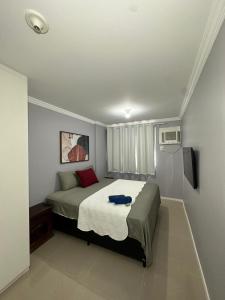 里约热内卢Suites W-Riocentro的一间带床和电视的小卧室