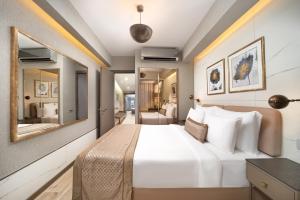 伊斯坦布尔Mula Hotel的配有一张大床和镜子的酒店客房