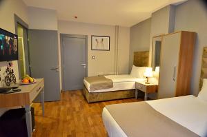 安卡拉Cadde 7 Otel的酒店客房配有两张床和一张书桌