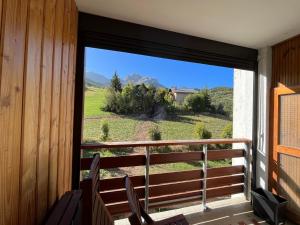 EnchastrayesAppartement T2 face aux pistes avec terrasse, 9 couchages, proche commerces et piscine - FR-1-165A-103的客房设有一个享有田野景致的窗户。