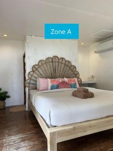 库德岛库德岛暹罗海滩度假村的一间卧室配有一张大床和木制床头板