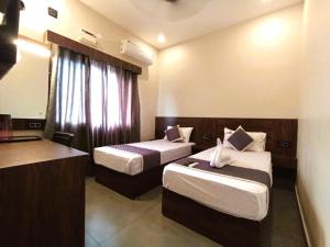 拉米斯瓦拉姆HOTEL ELITE的酒店客房带两张床和厨房
