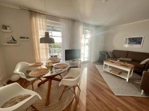 罗斯托克Traumwohnung mit Stadthafen-Panorama! Zwei Schlafzimmer, Parkplatz的客厅配有桌子和沙发