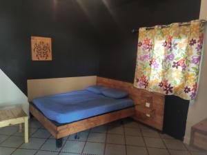 努瓦克肖特Auberge-Café-Restaurant TUNIS的一间卧室配有一张带蓝色床单的床和一扇窗户。