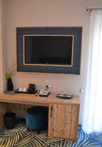 锡比乌ART Hotel的一间设有一张桌子的房间,墙上配有电视
