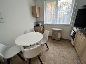 亚斯贝雷尼Karman Apartman - 2 bedroom entire flat in the center的小厨房配有白色的桌子和椅子