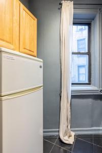纽约Apartment 242: Upper West Side的厨房配有冰箱和窗户。
