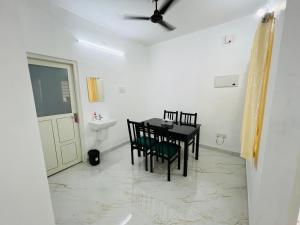 ThanniyamFurnished 2 BHK Family Apartments near Triprayar Shree Rama Temple - Beevees Homes Thriprayar的一间带桌椅和水槽的用餐室
