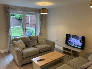 阿什伯恩Beautiful Cottage in Ashbourne的带沙发和平面电视的客厅