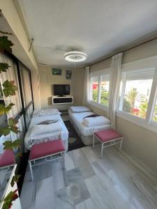 马贝拉Puerto Banus的客房设有两张床、一台电视和窗户。