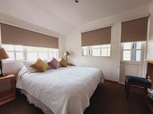 普孔杰罗尼莫宾馆的卧室设有一张带窗户的白色大床