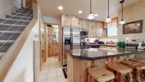 斯诺马斯村Tamarack Townhomes - CoralTree Residence Collection的厨房配有木制橱柜和台面