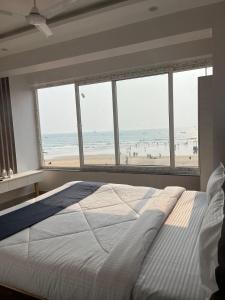 巴加Baga beach front的一间卧室配有一张床,享有海滩美景