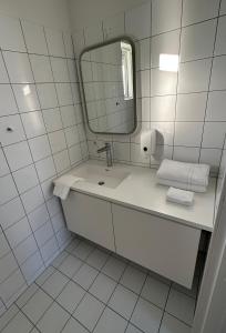 海拉农夫度假屋的白色的浴室设有水槽和镜子