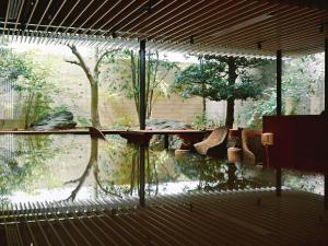 金泽Mitsui Garden Hotel Kanazawa的一个带桌子的天井,水中反射