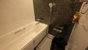 屋久岛THE HOTEL YAKUSHIMA ocean & forest的浴室配有白色浴缸和卫生间。