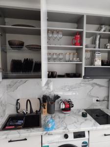 卡拉甘达Квартира的厨房配有白色大理石台面和水槽