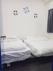 伯恩仓BLUE DOME (Santorini) @ Night Market, Cameron Highlands的两张睡床彼此相邻,位于一个房间里