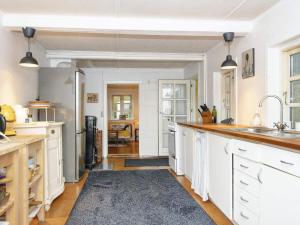 斯坎讷堡5 person holiday home in Skanderborg的一间大厨房,配有白色的橱柜和水槽