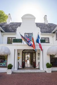 开普敦安德罗斯精品酒店的前面悬挂着旗帜的白色建筑