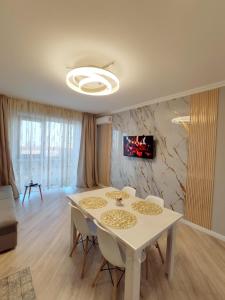 阿拉木图Красивая новая квартира в центре города的一间配备有白色桌椅的用餐室