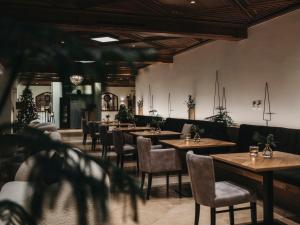 蓬高圣约翰欧博弗斯特霍夫酒店的用餐室配有木桌和椅子